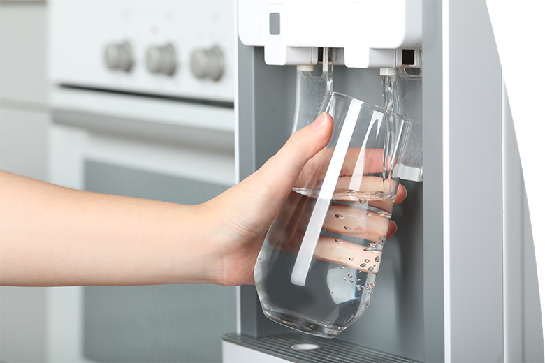 Woman filling glass with water cooler indoors, closeup. Refreshing drink